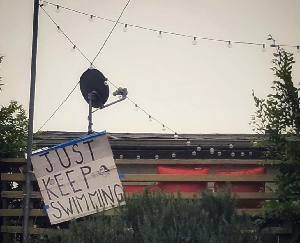 Sign outside that says Just Keep Swimming